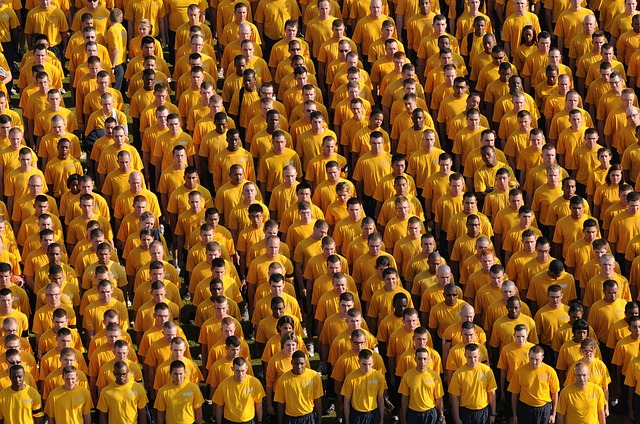 large crowd of men all looking the same with yellow shirts