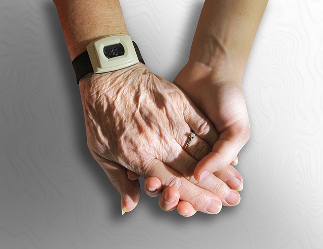 old person and young person holding hands