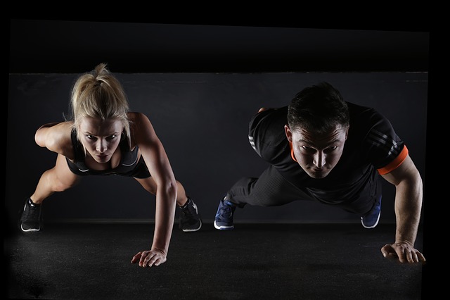 man and woman doing a push up