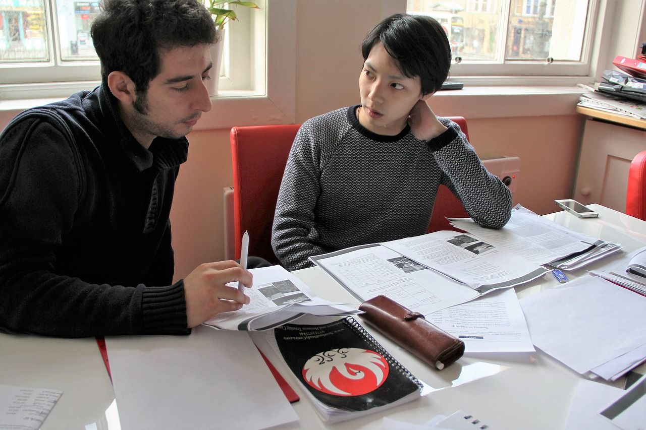 student talking with teraching at her office