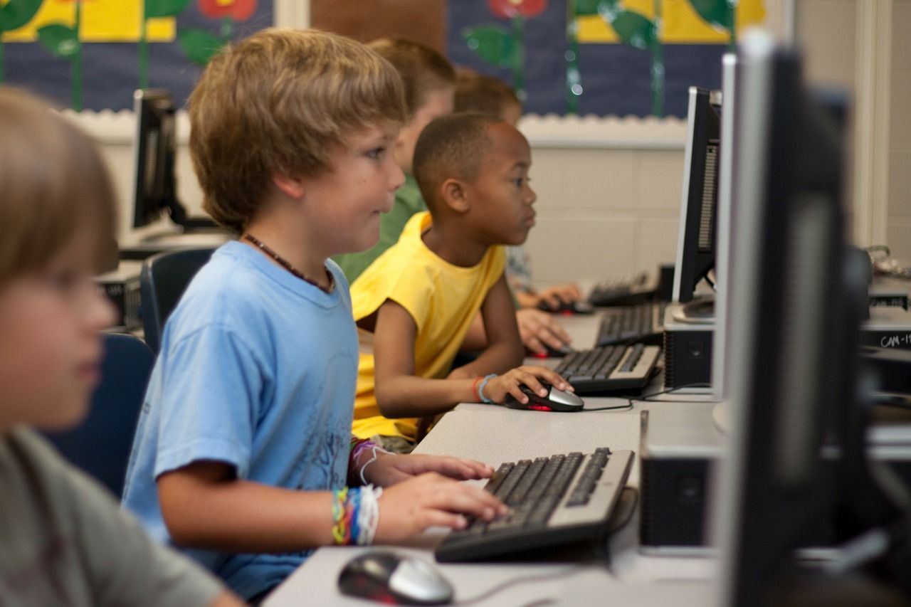 young children working at computers in school