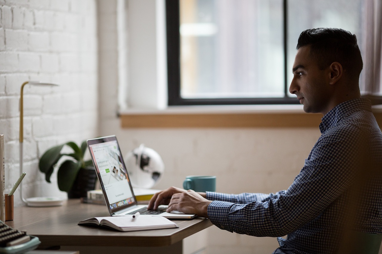 researcher at his desk working on a computer