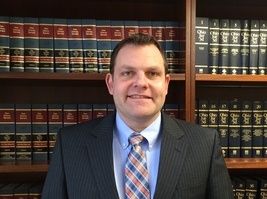 lawyer standing in front of law books