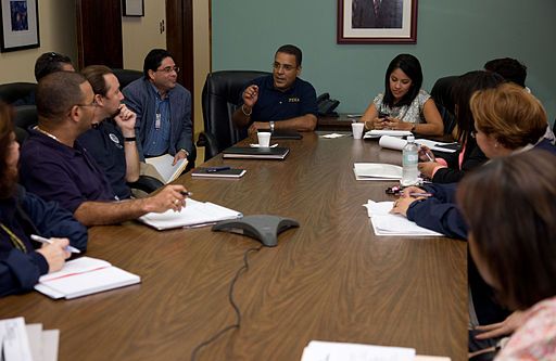 mediator at front of table helping two sides of people around table