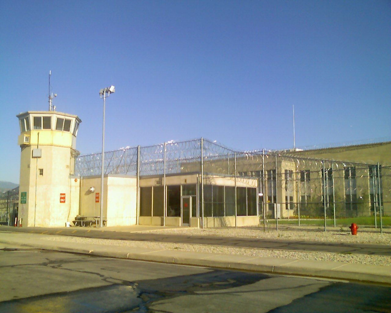 outside of prison showing wire fence