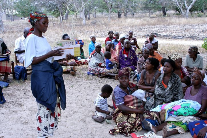 health worker talks to villagers