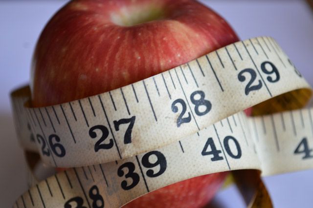 apple with a tape measure around it