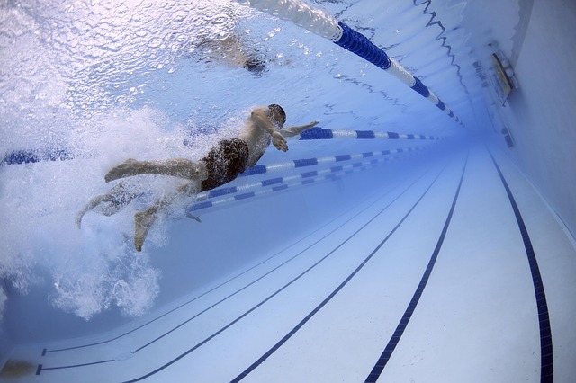 male athlete swimming in pool