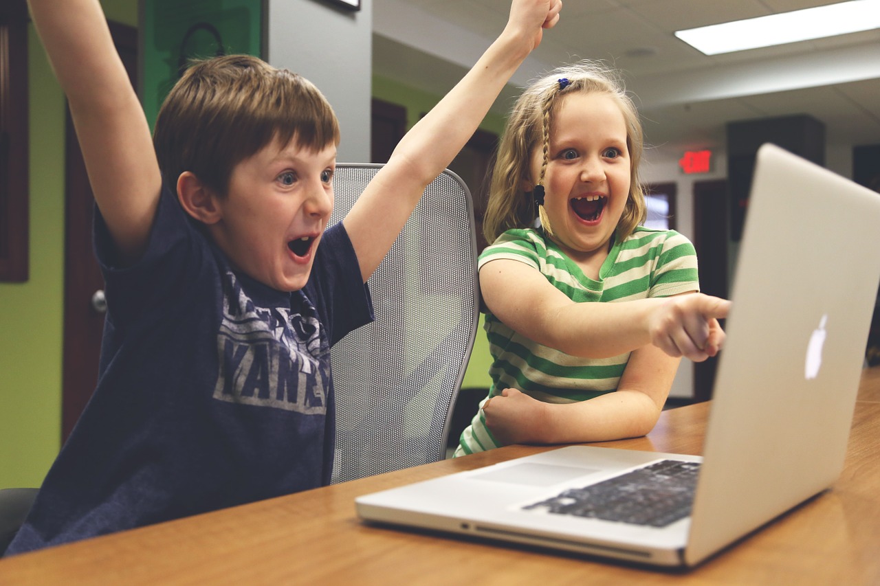 boy and girl working together at computer