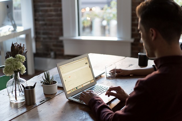 man working at computer at his desk