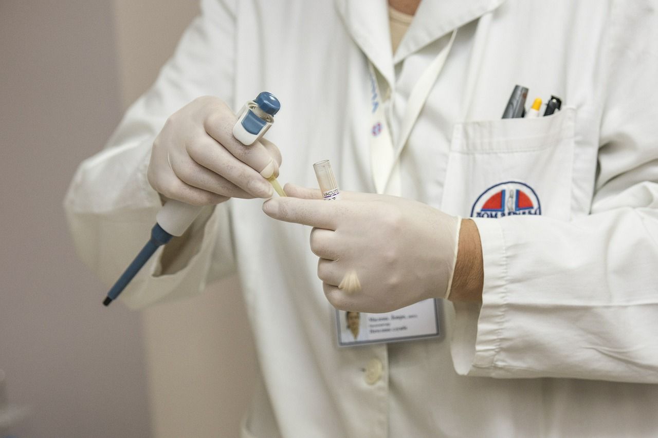 physician assistant wearing lab coat with medical devices