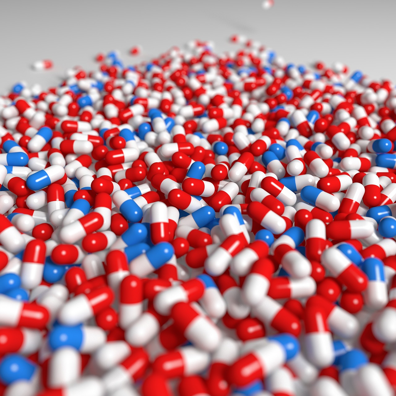 large pile of red, white, and blue pills
