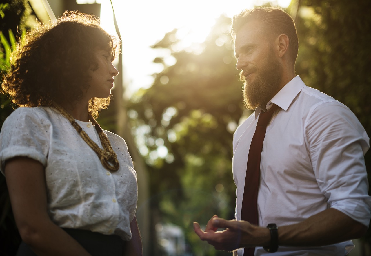 pastoral counselor with beard talking to woman