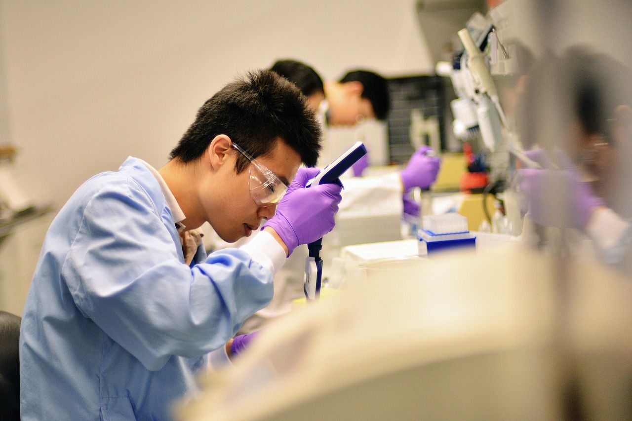 asian researcher in blue labcoat