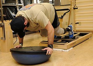 man with artifical legs doing physical therapy in a laying-down position